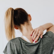 woman putting hand on neck- Osteoarthritis treatment